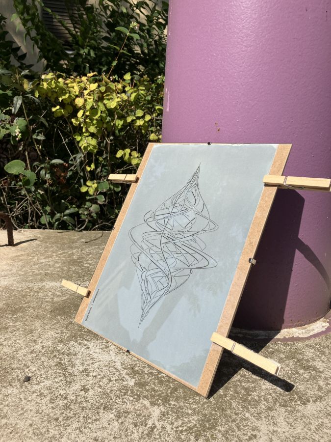 Abstract wavy image in a clip frame: it's the tracing paper drawing in front of cyanotype paper. The contraption is leaning against a purple column somewhere outside, in strong direct sunlight.