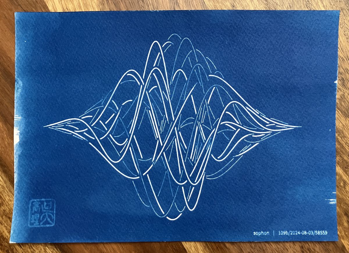 Finished cyanotype print of the generative wavy shapes, which are in crisp white against the deep blue background