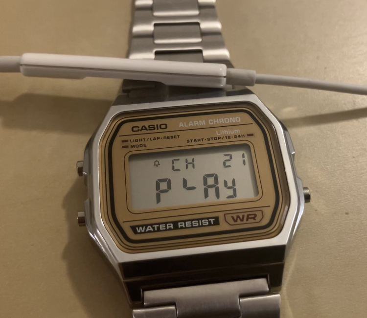 A modified Casio watch with a headset microphone over it.